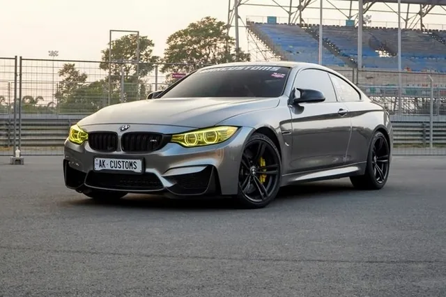 A grey BMW M4 parked at a circuit